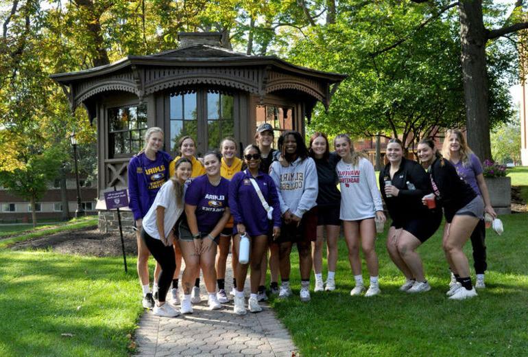 A group of female students smile in front of the Mark Twain Study